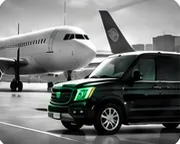 Black chauffeur van waiting beside a passenger jet for an airport transfer